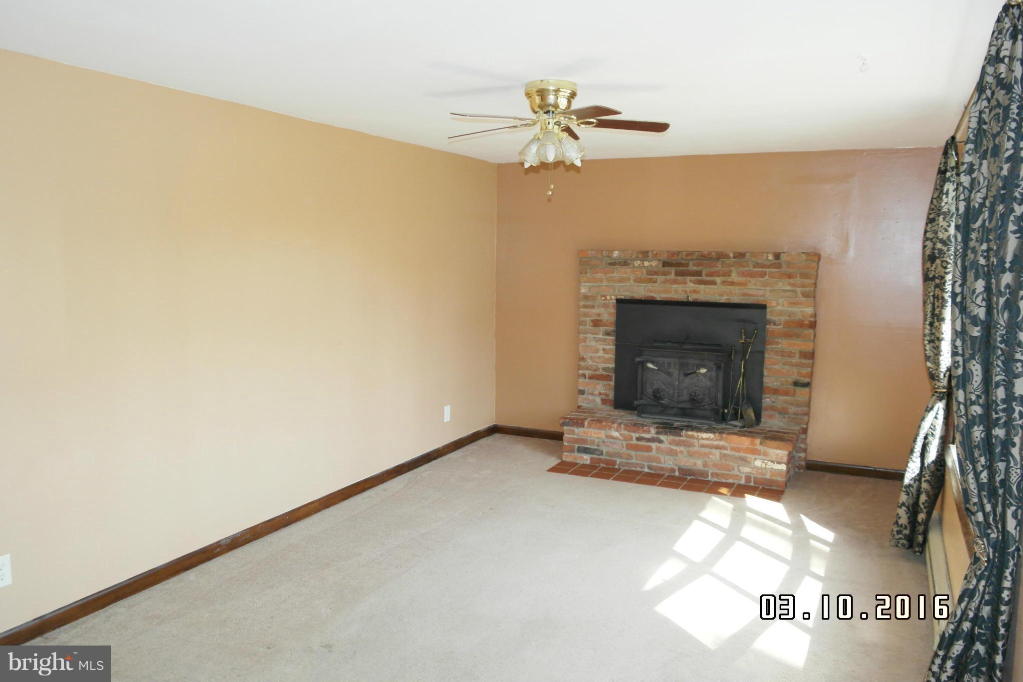 4524 Elmer Derr Road Frederick, MD 21703 - Photo 5 of 15 a view of an empty room with a fireplace