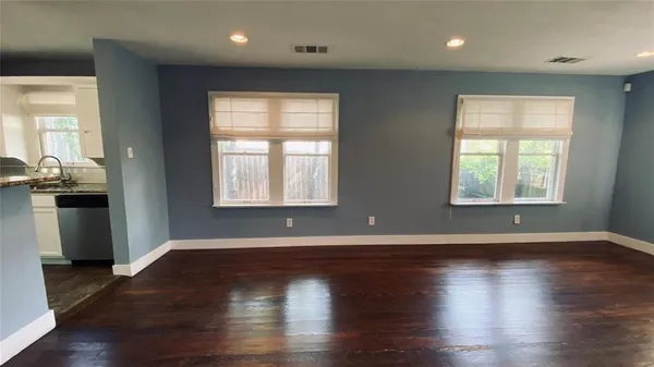 a view of a kitchen with a sink and windows