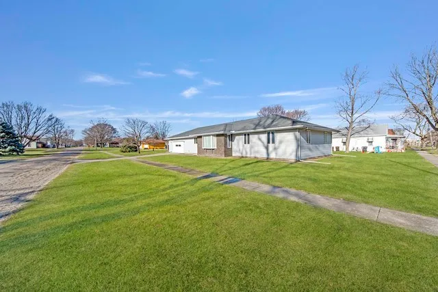 a house view with swimming pool in front of it