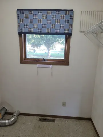 a view of a wooden door and a window
