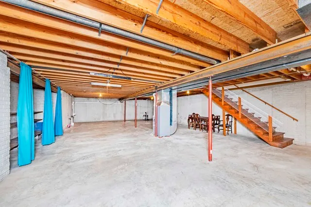 a front view of a house with garden and trees