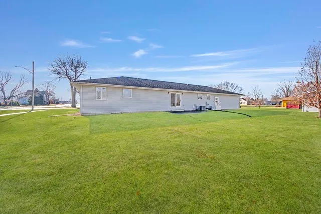 a view of a backyard with table and chairs and a yard