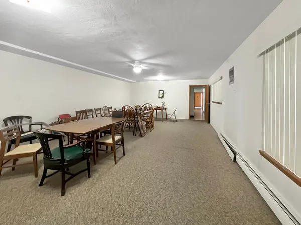 a dining room with furniture and a chandelier