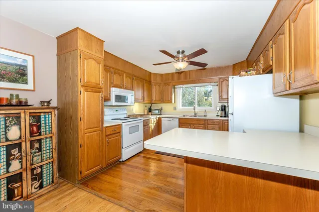 a kitchen with a white cabinets and white appliances