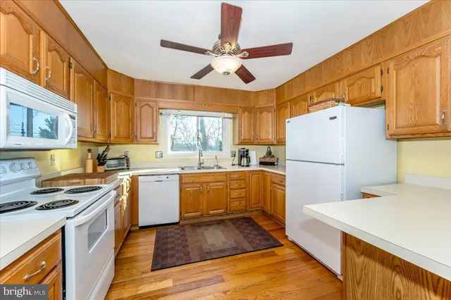 a kitchen with stainless steel appliances granite countertop a stove sink and cabinets