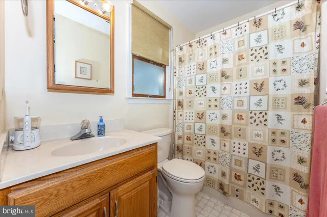 a bedroom with a bed and a ceiling fan