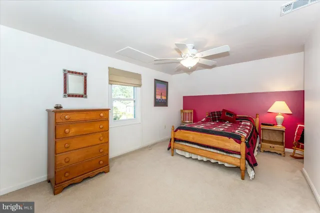 a bedroom with a bed and a chair