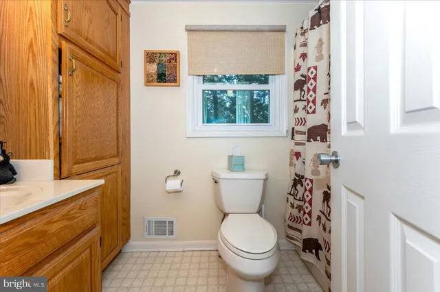 a view of a room with wooden floor and cabinet