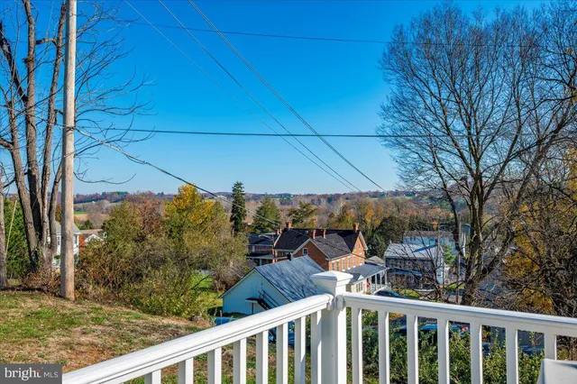 a view of deck with wooden floor and fence and a floor to ceiling window
