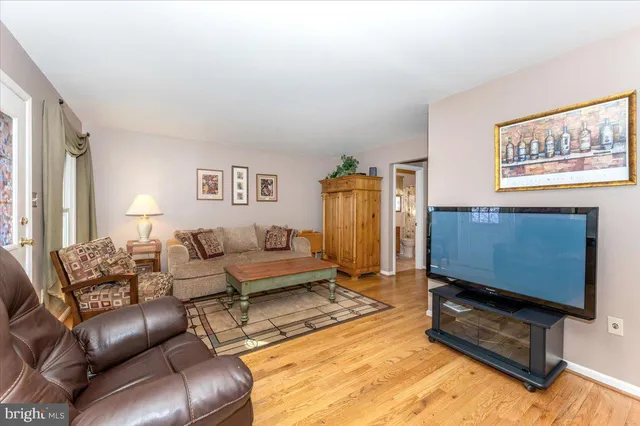 a living room with furniture a dining table and a potted plant