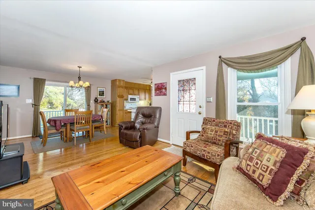 a living room with furniture window and wooden floor