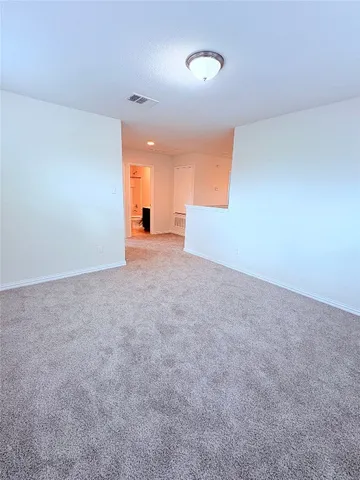 a view of an empty room and a window