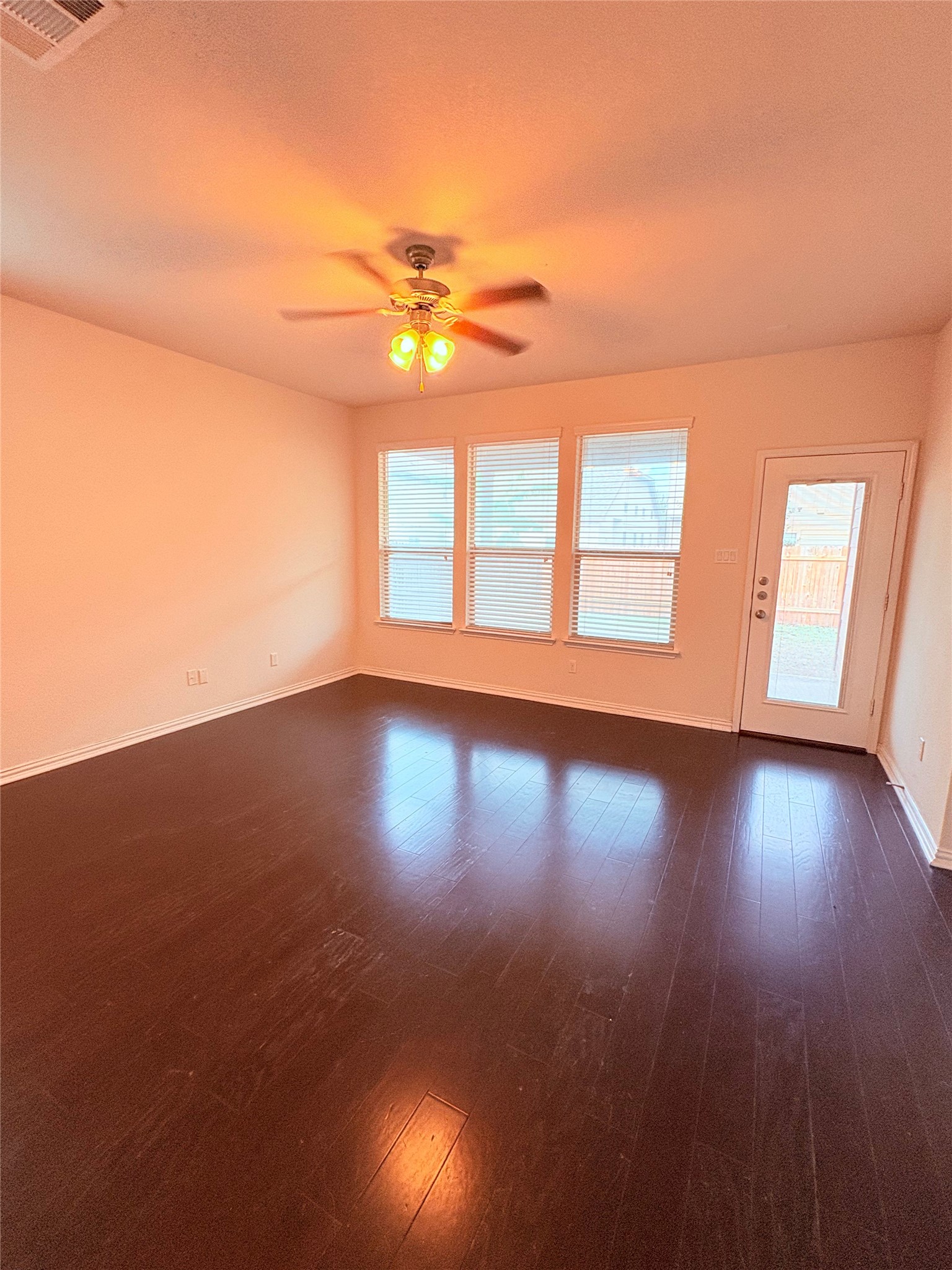 16029 Hampton Bliss Trace Austin, TX 78728 - Photo 6 of 15 a view of empty room with wooden floor and fan