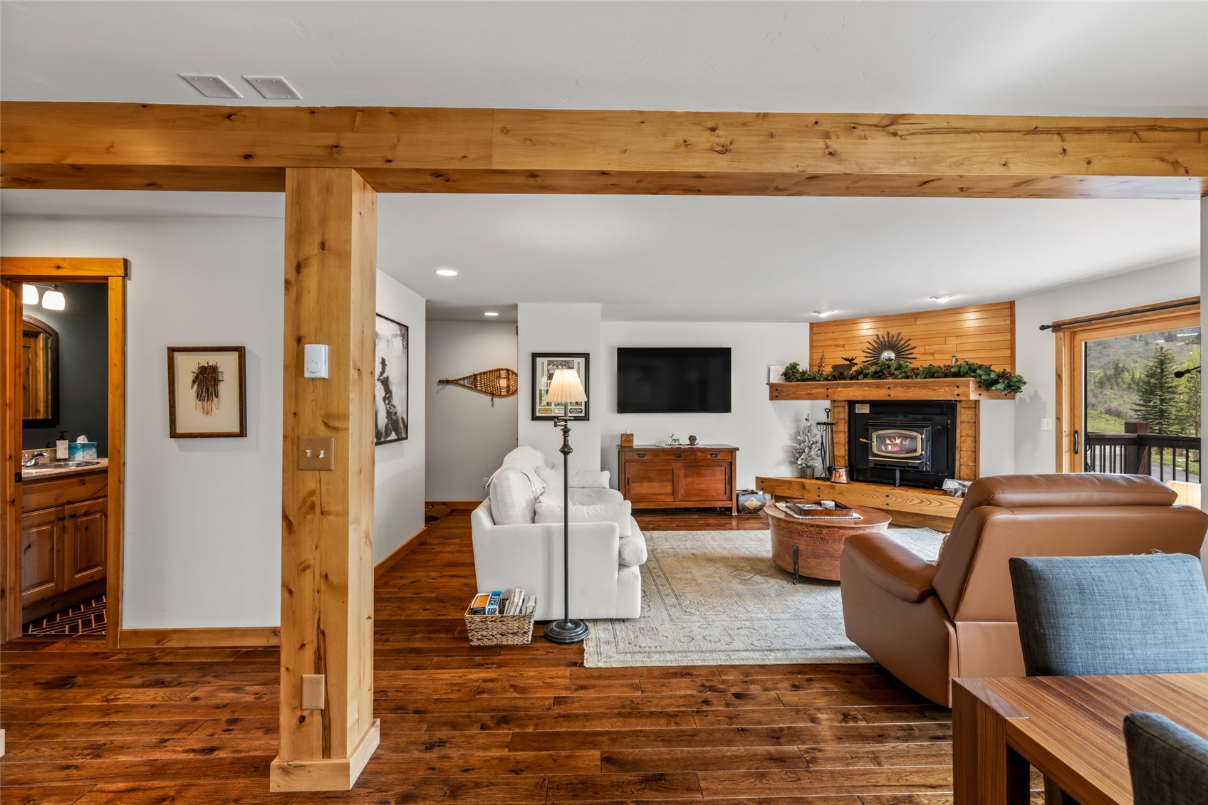 1655 Ranch Road, Unit 403 Steamboat Springs, CO 80487 - Photo 5 of 36 Living room featuring wood finished floors, a glass covered fireplace, recessed lighting