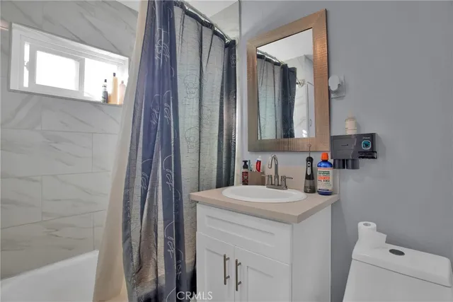 a bathroom with a sink vanity and a mirror