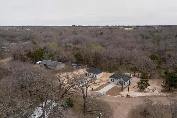 an aerial view of a house with a yard