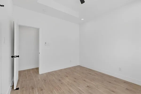 a view of a room with wooden floor