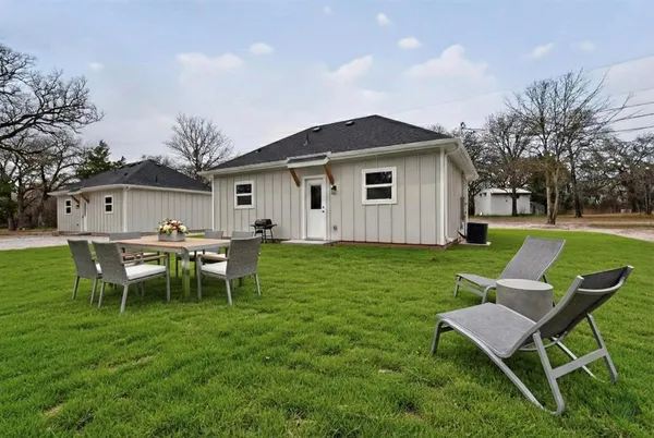 a view of a house with a backyard and a patio