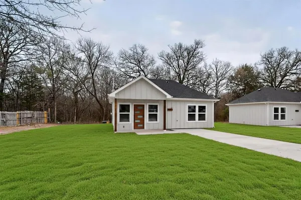a front view of house with yard and green space