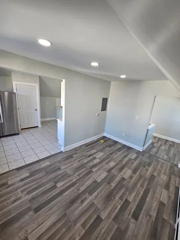 a view of a room with wooden floor and staircase