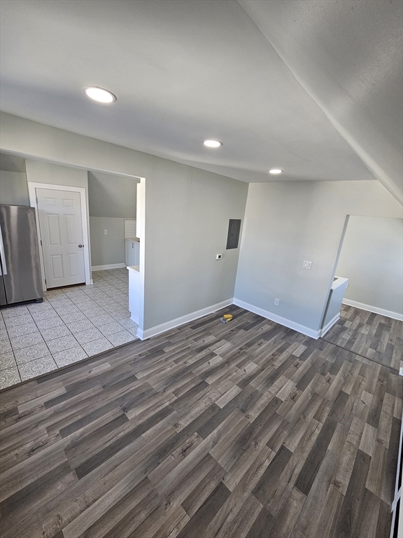 a view of a room with wooden floor and staircase