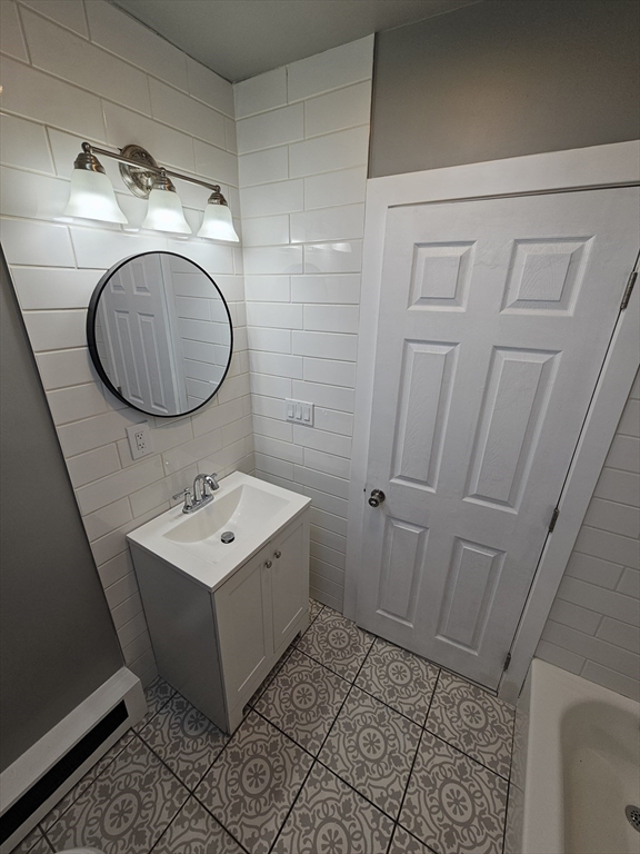46 Dennis Street, Unit 3 Boston, MA 02119 - Photo 11 of 22 a bathroom with a sink and mirror