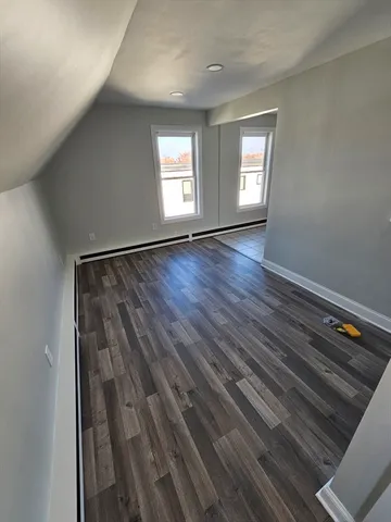 wooden floor in an empty room with a fireplace