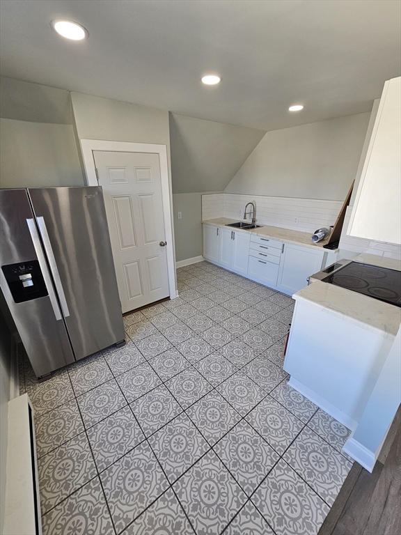 46 Dennis Street, Unit 3 Boston, MA 02119 - Photo 19 of 22 a view of a livingroom with wooden floor and staircase
