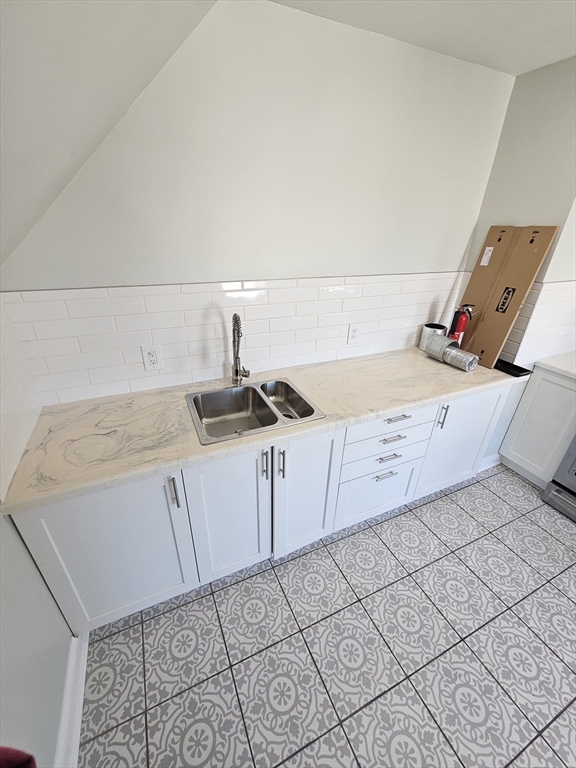 46 Dennis Street, Unit 3 Boston, MA 02119 - Photo 20 of 22 a kitchen with a sink and cabinets