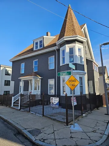 a view of the house with a swimming pool and sitting area