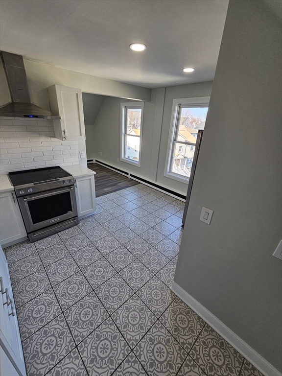 46 Dennis Street, Unit 3 Boston, MA 02119 - Photo 21 of 22 wooden floor in an empty room with a fireplace