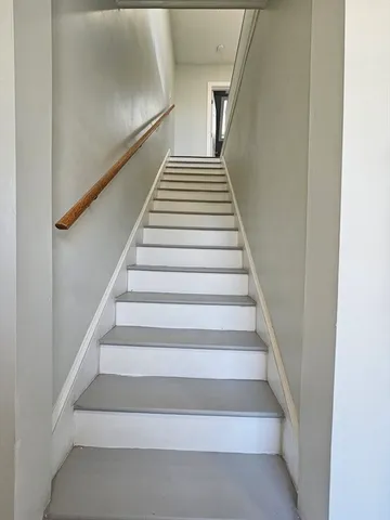 a bathroom with a toilet and a window