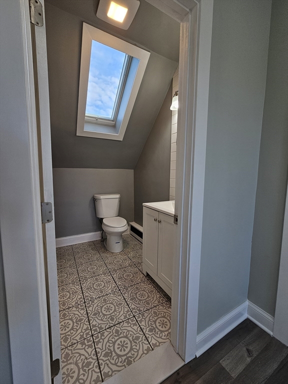 46 Dennis Street, Unit 3 Boston, MA 02119 - Photo 8 of 22 a bathroom with a toilet and a window