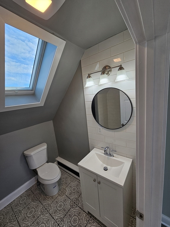 46 Dennis Street, Unit 3 Boston, MA 02119 - Photo 9 of 22 a bathroom with a toilet sink and mirror