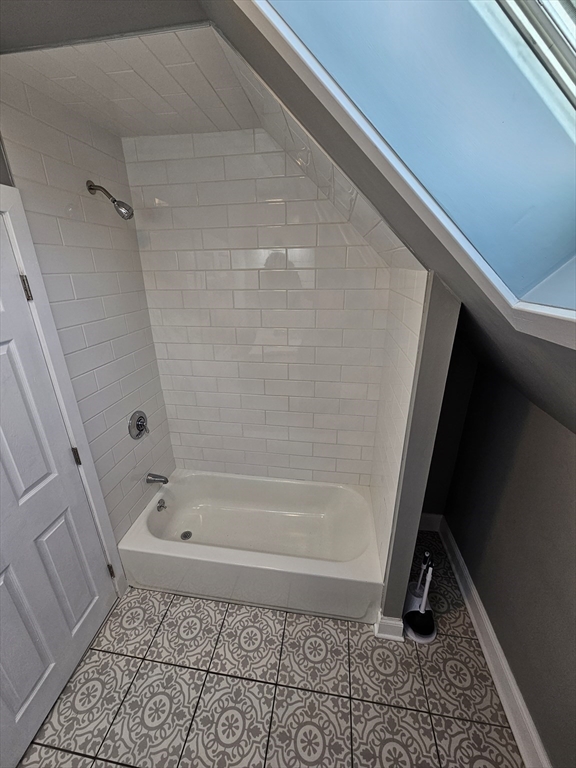 46 Dennis Street, Unit 3 Boston, MA 02119 - Photo 10 of 22 a bathroom with a bath tub and a shower
