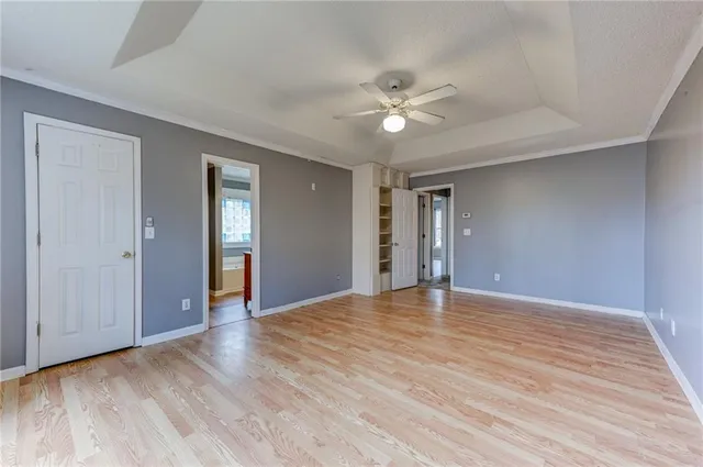 a view of an empty room with wooden floor