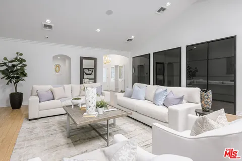 a kitchen with stainless steel appliances granite countertop a sink a stove top oven a counter space and cabinets