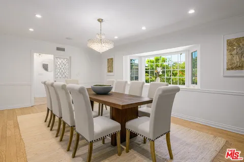 a kitchen with stainless steel appliances granite countertop a stove a sink a oven and a refrigerator