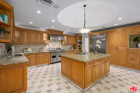 a kitchen with a window a sink and a counter in it