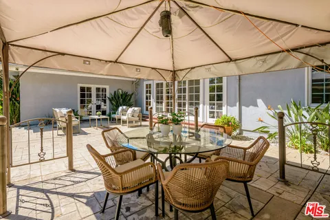 a view of a house with pool porch and chairs