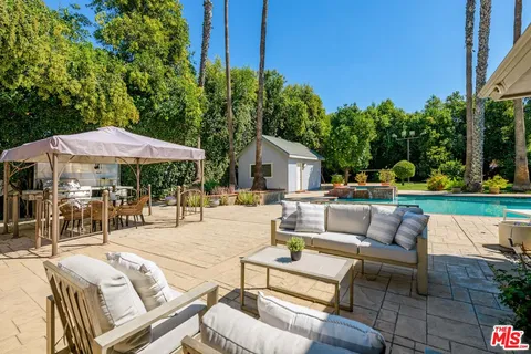 a view of house with swimming pool yard and outdoor seating