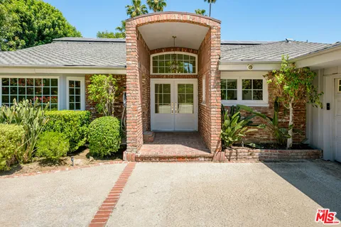 a living room with fireplace furniture and a wooden floor
