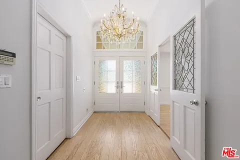 a living room with furniture a fireplace and a floor to ceiling window