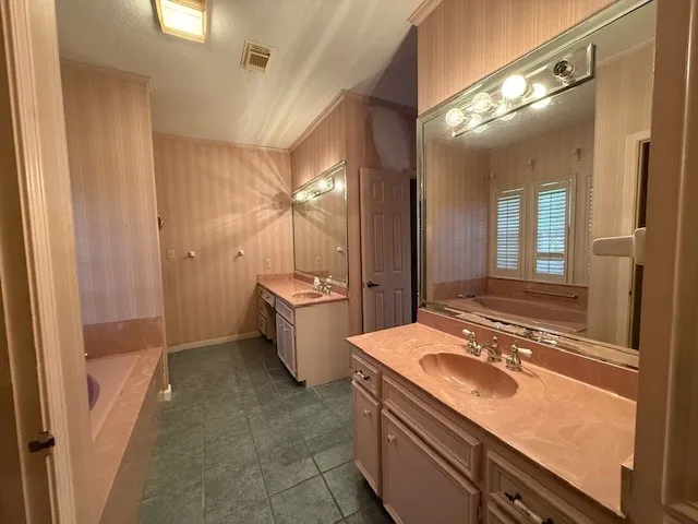 a bathroom with a sink double vanity granite and a mirror