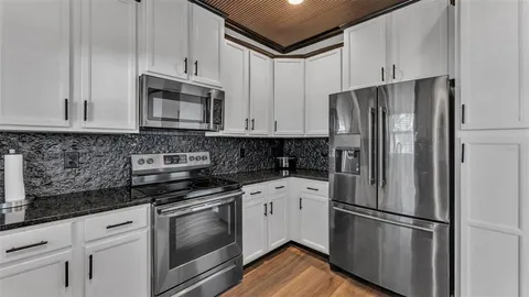a kitchen with kitchen island a counter top space and a sink