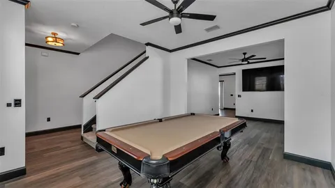 a hallway with wooden floor and furniture