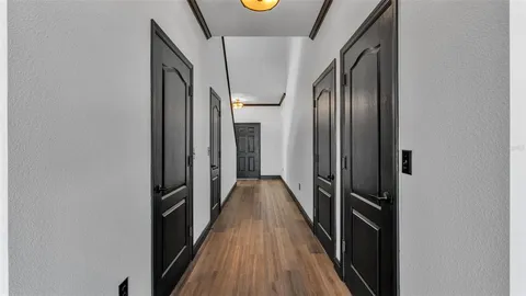 a view of a livingroom with wooden floor and windows