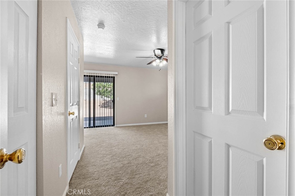 13904 Hidden Valley Road Victorville, CA 92395 - Photo 20 of 47 a view of a hallway with wooden shelves