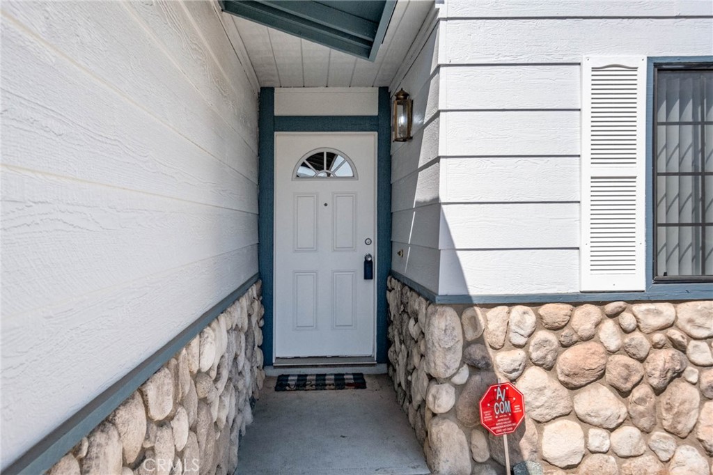 13904 Hidden Valley Road Victorville, CA 92395 - Photo 28 of 47 a view of a wooden door with a bench