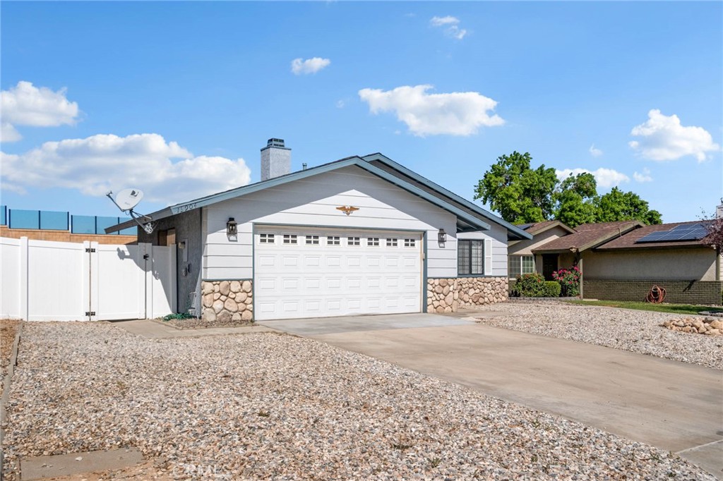 13904 Hidden Valley Road Victorville, CA 92395 - Photo 30 of 47 a view of a house with a yard and garage
